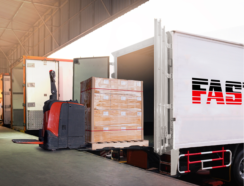 Forklift unloading boxes from a truck in a warehouse setting
