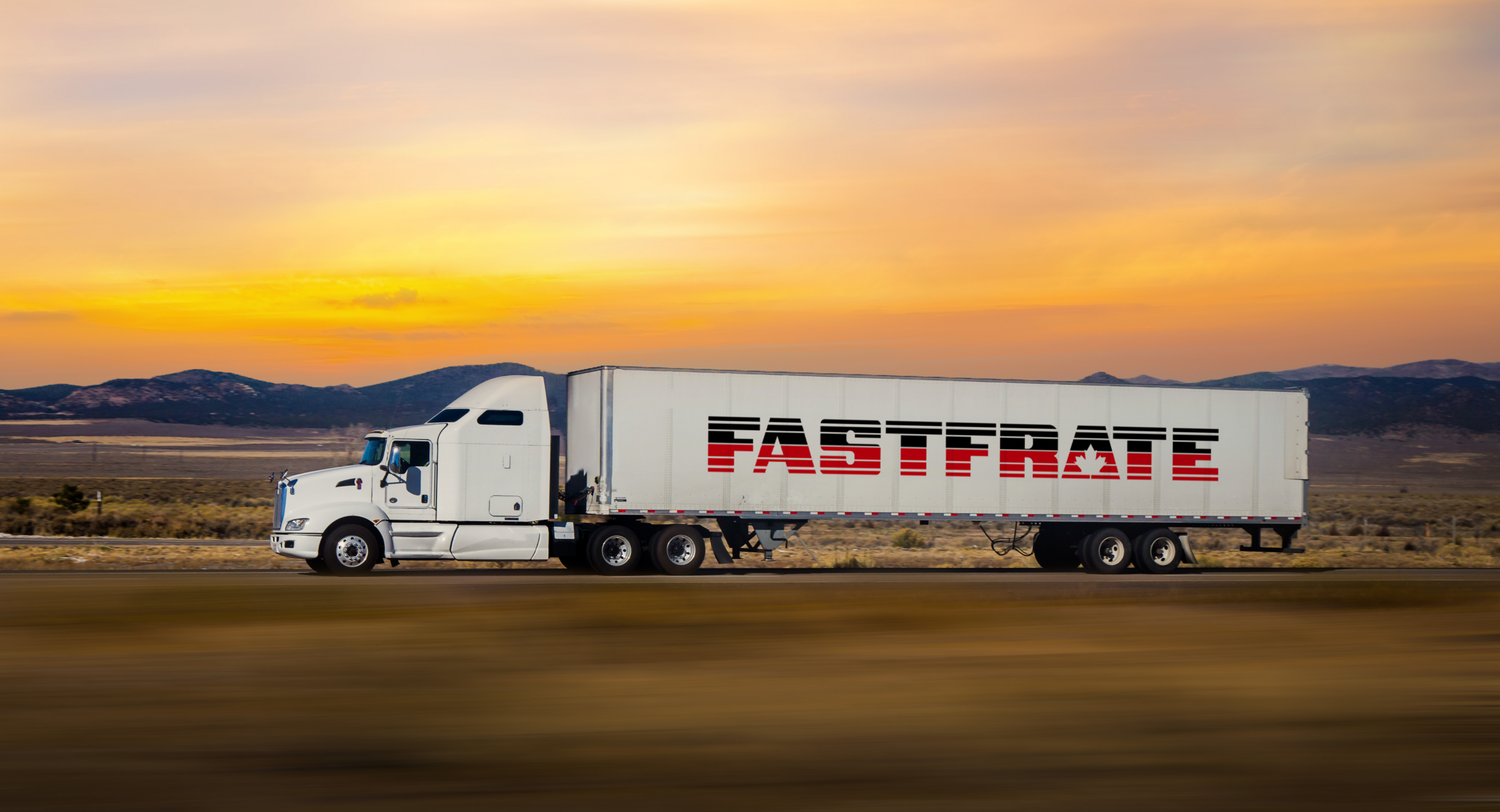 White truck with "FASTFRATE" logo driving through a sunset landscape