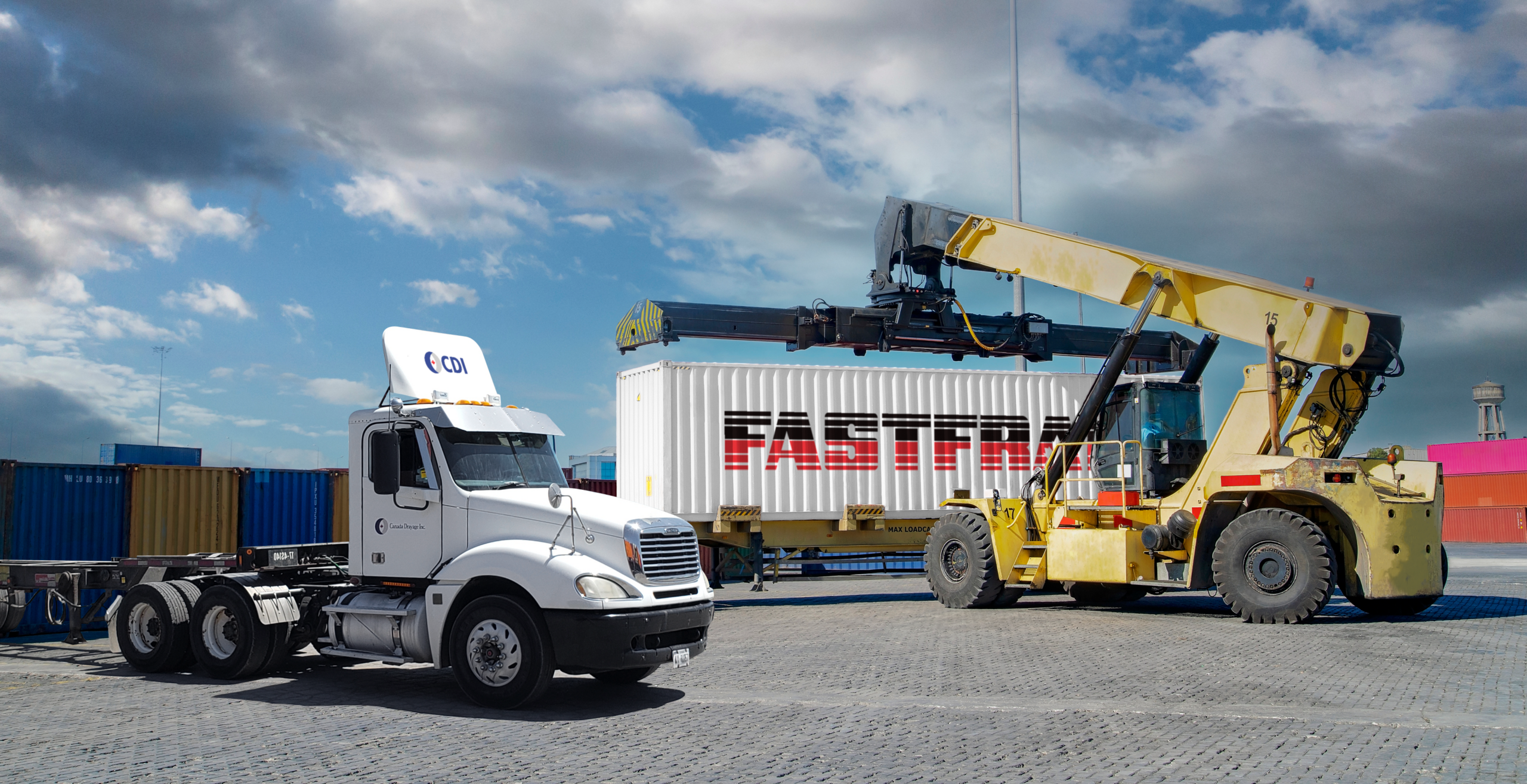 Truck and container handler at a shipping yard under a cloudy sky