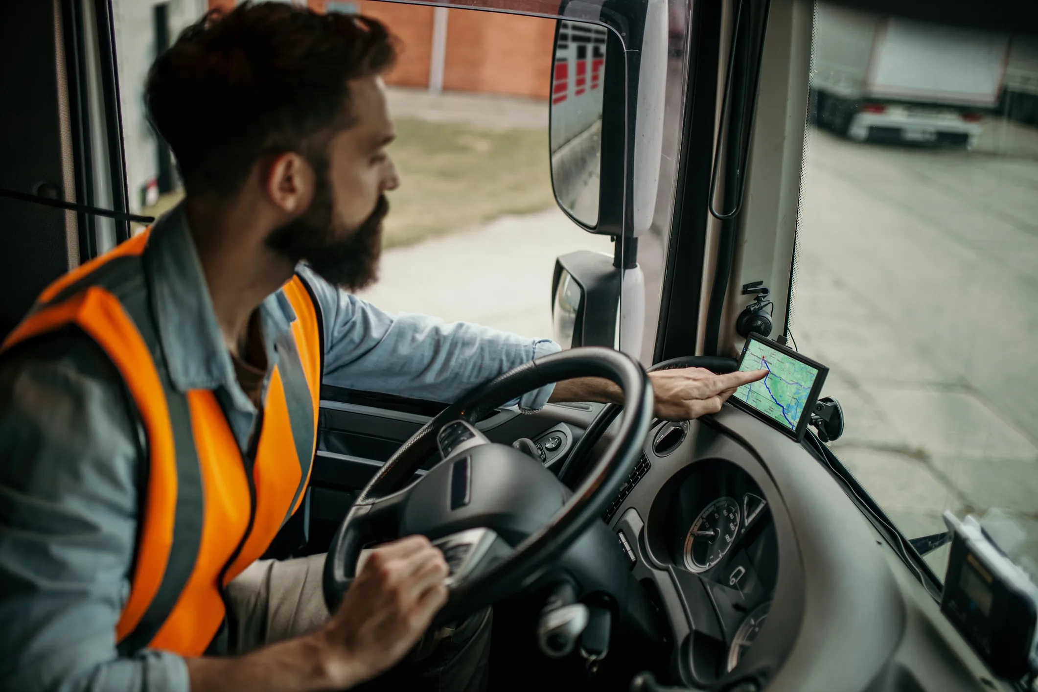 Truck driver using GPS while navigating the road