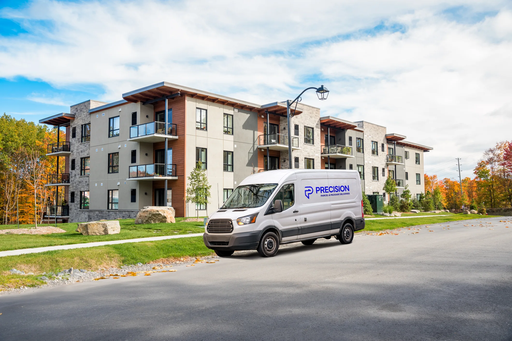 Delivery van parked in front of a modern apartment building