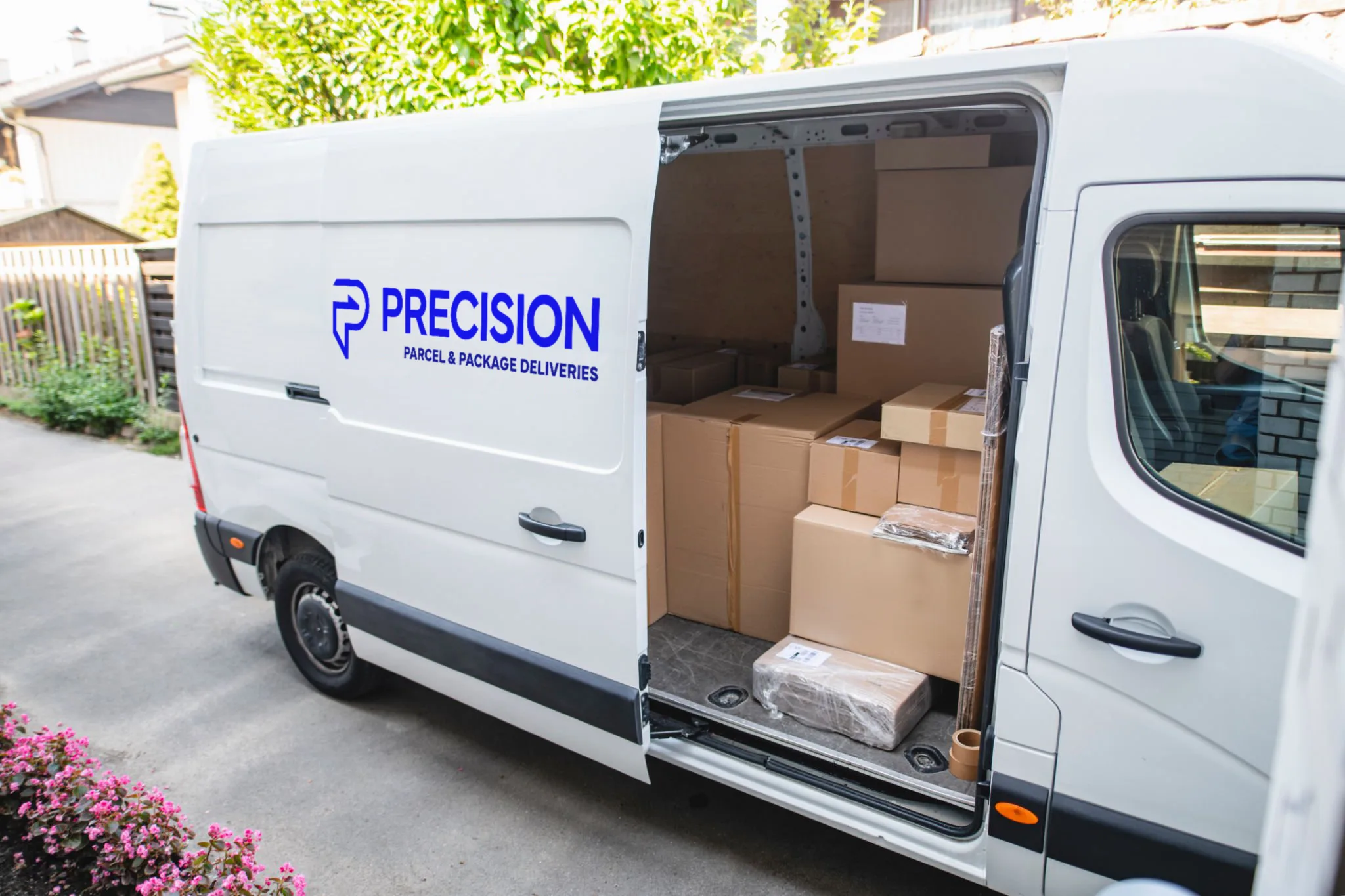 Delivery van loaded with cardboard boxes, parked in a residential area