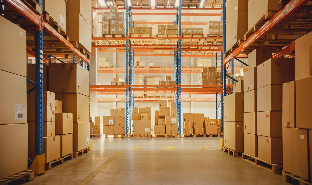 Warehouse interior filled with stacked cardboard boxes on shelves