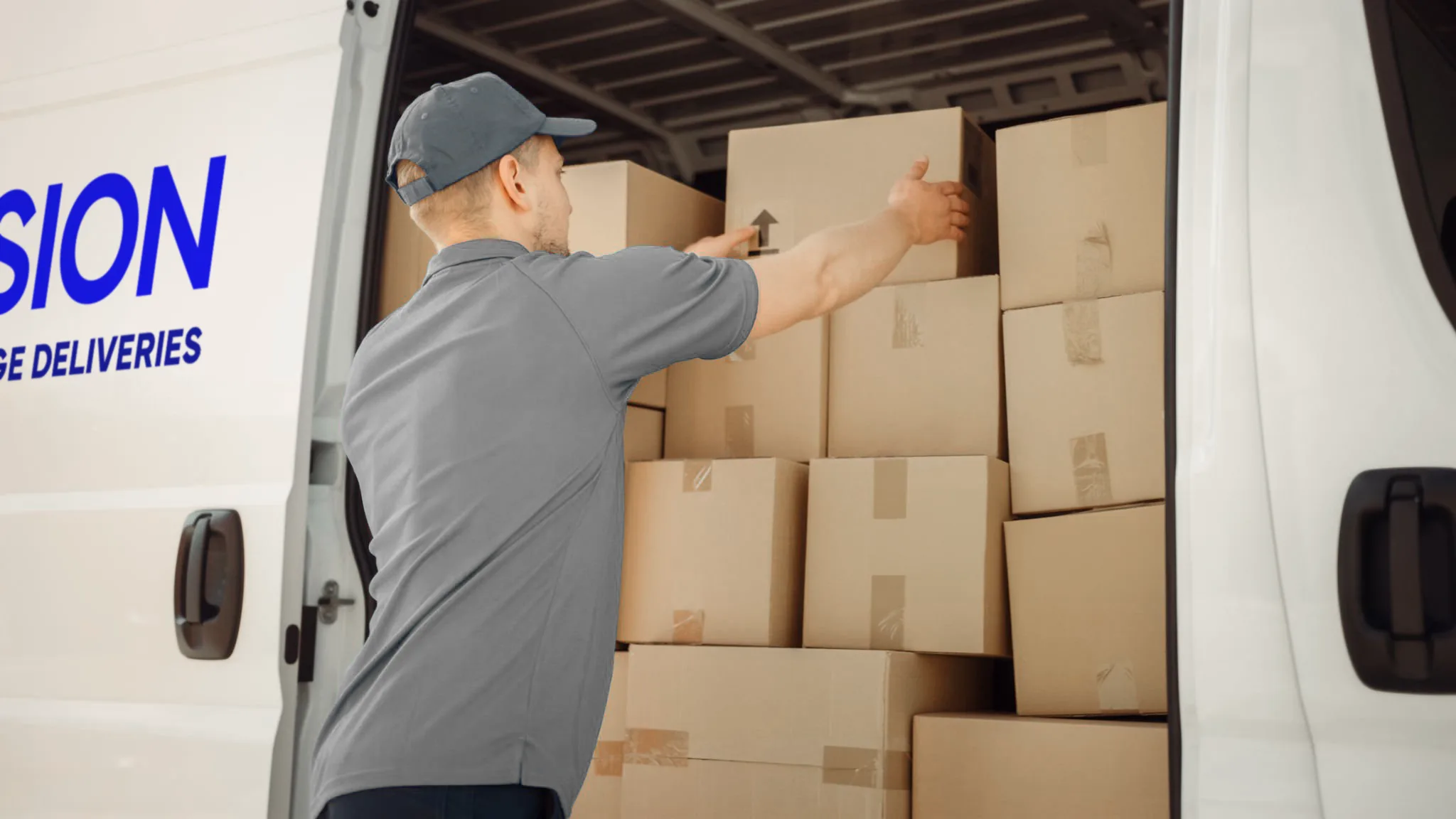 Delivery worker loading boxes into a van for freight solutions