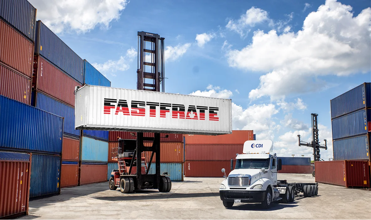 Truck and container crane at a shipping yard with colorful containers