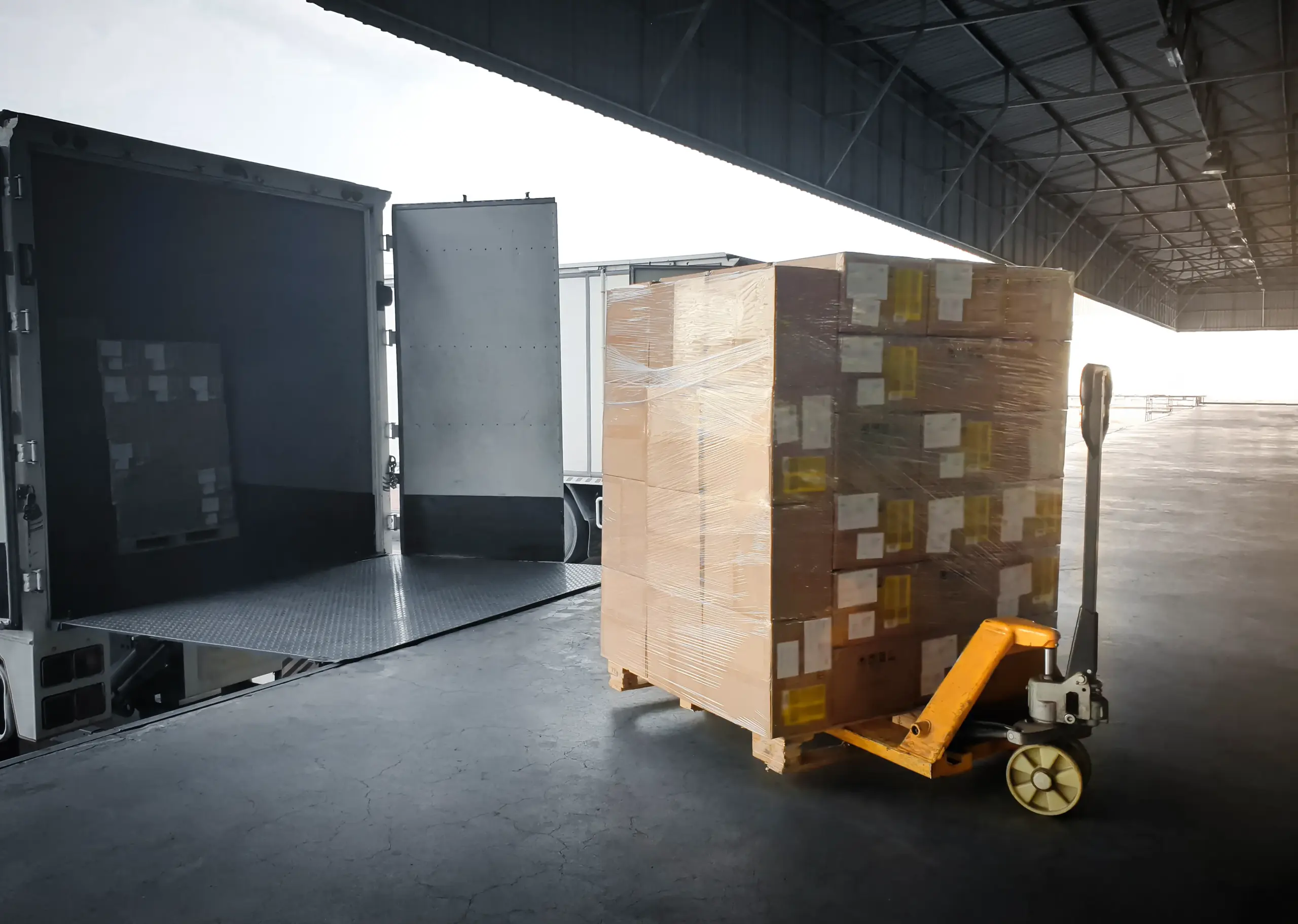 Pallet of boxes on a hand truck near a loading dock